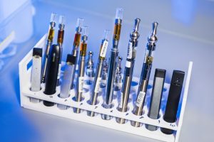 a test tube rack that had been stocked with examples of various electronic cigarettes, referred to as e-cigarettes, or e-cigs, and vape pens. These items would undergo testing inside a Centers for Disease Control and Prevention (CDC) laboratory environment.