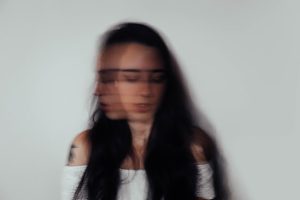 a girl with blurry picture and shaking her head