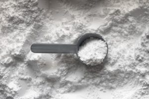 One scoop of white creatine monohydrate powder. 